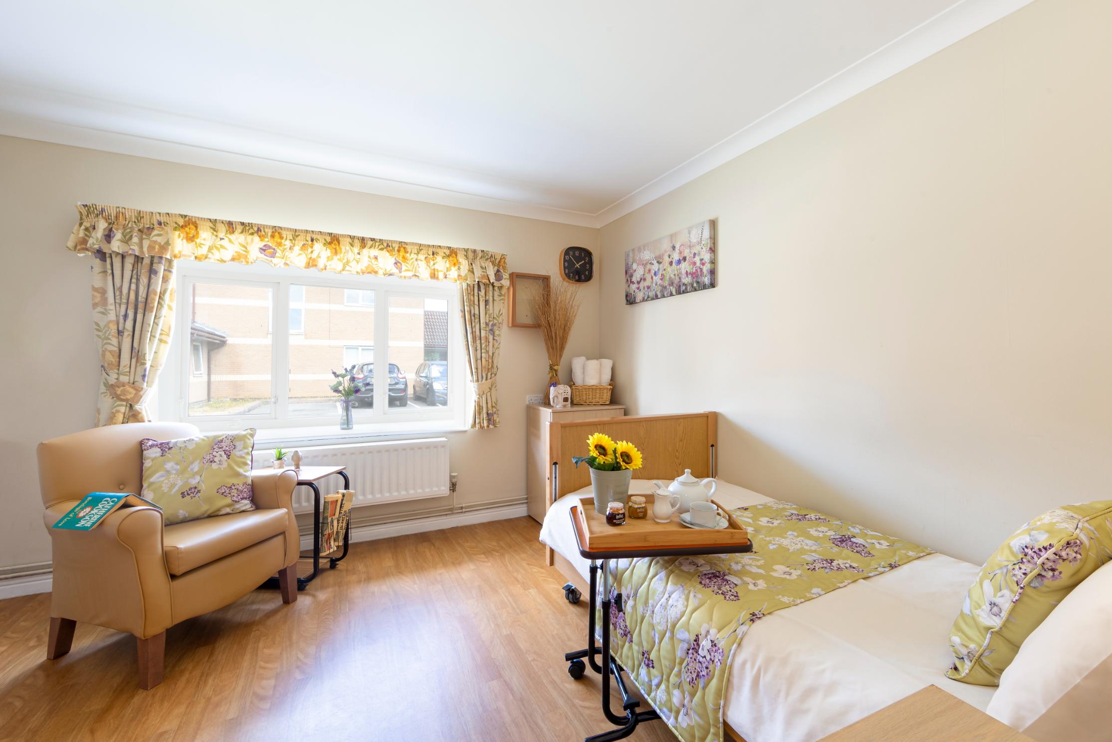 bedroom with flower blanket on the bed